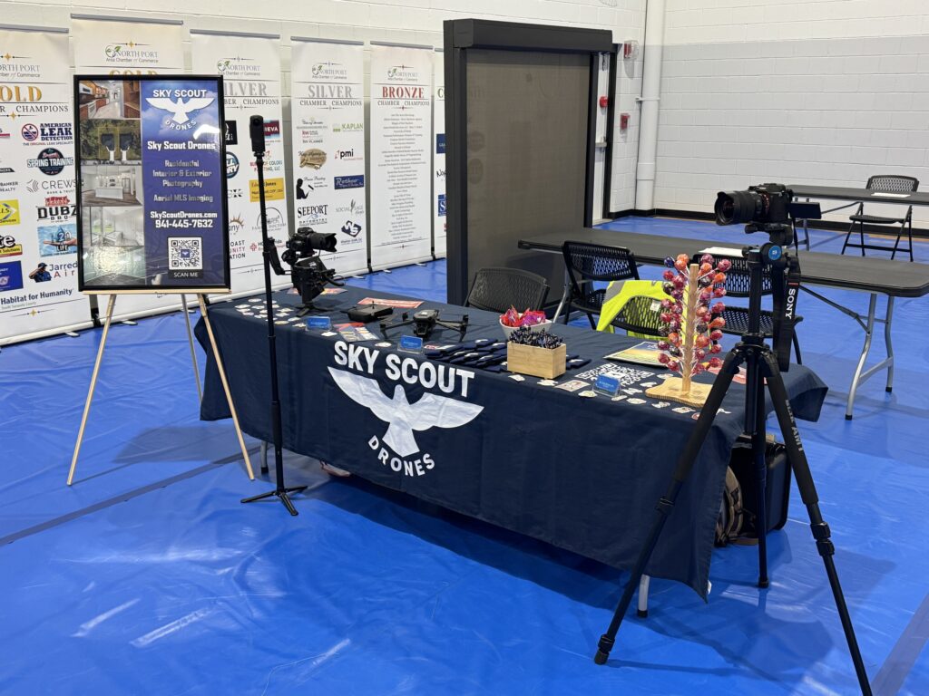 Sky Scout Drones booth displaying drone equipment and marketing materials at a community event