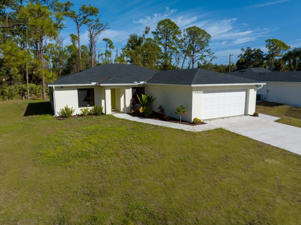 Aerial front view of a residential home showing the entrance, garage and front yard