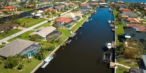 Damaged waterfront houses after hurricane Ian in Florida residential area. Consequences of natural disaster.