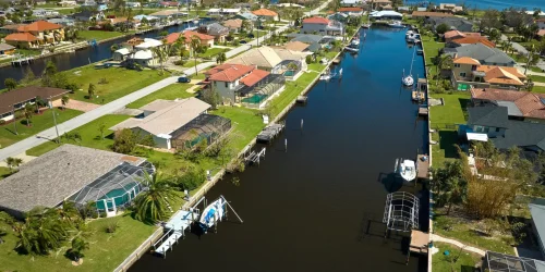 Damaged waterfront houses after hurricane Ian in Florida residential area. Consequences of natural disaster.